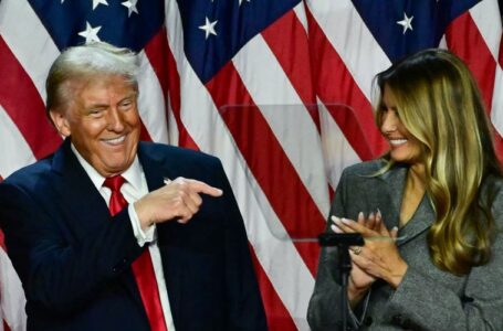 Former US President and Republican presidential candidate Donald Trump points to his wife former US First Lady Melania Trump during an election night event at the West Palm Beach Convention Center in West Palm Beach, Florida, early on November 6, 2024. (Photo by Jim WATSON / AFP)